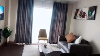 a living room with a couch and a window at Menlyn Bizcation Accommodation in Pretoria