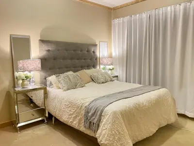 a bedroom with a large bed and a window at Siena Sun Luxury Suites in Erand