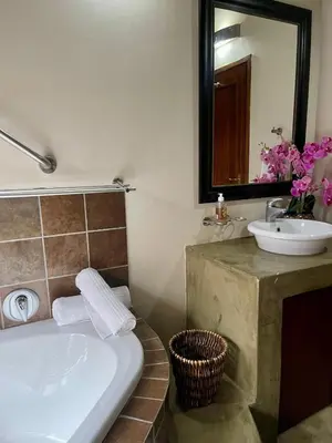 a bathroom with a bath tub and a sink at 213 Zebula Golf Estate & Spa - 4 Bedroom Home in Mabula