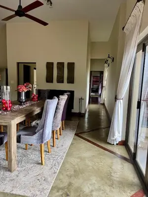 a dining room with a table and chairs at 213 Zebula Golf Estate & Spa - 4 Bedroom Home in Mabula