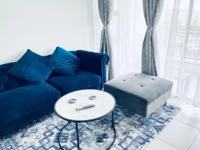 a living room with a blue couch and a table at The Blyde Crystal Lagoon Bliss in Pretoria