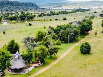 an aerial view of a farm with a field and trees at Sambane Game Lodge in Bracondale