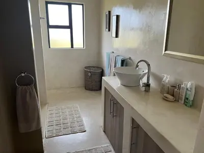 a bathroom with a sink and a counter with a mirror at Sambane Game Lodge in Bracondale