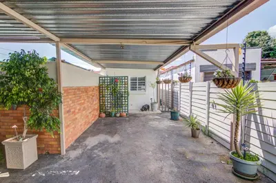 an empty garage with plants and a brick wall at Ovendales Self Catering Cottage in Benoni