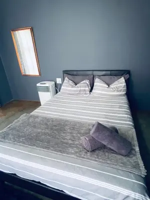 a bed with two towels sitting on top of it at Ha-Dzibs backpackers accommodation in Thohoyandou