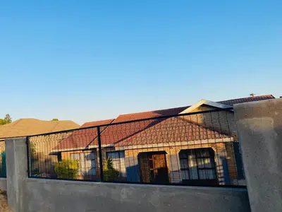 a house with a fence on the side of it at Ha-Dzibs backpackers accommodation in Thohoyandou