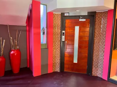 a hallway with a door with colorful walls and vases at Solitaire Guest Apartments in Pretoria