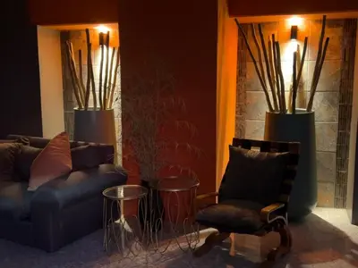 a living room with a couch and a chair at Solitaire Guest Apartments in Pretoria