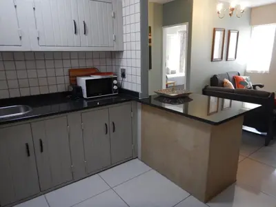 a kitchen with a counter top and a microwave at Solitaire Guest Apartments in Pretoria