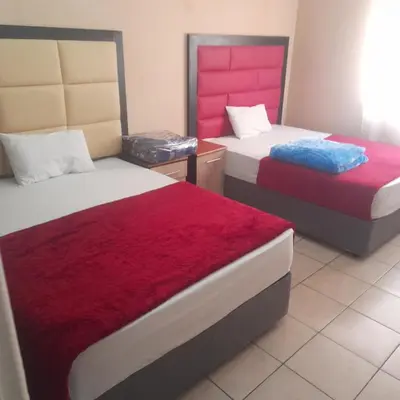 a bedroom with two beds with red and white sheets at Cozy guesthouse springs in Springs