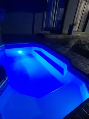 a swimming pool with blue lights in a room at Cozy guesthouse springs in Springs