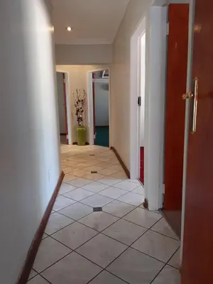 an empty hallway with a tile floor in a house at Brovad Guesthouse in Kempton Park