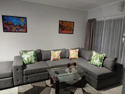a living room with a couch and a table at Craiden Holiday Apartment at The Blyde Crystal Lagoon 2 bedrooms in Pretoria