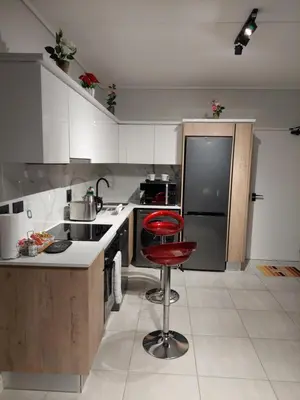 a kitchen with a red stool in a kitchen at Craiden Holiday Apartment at The Blyde Crystal Lagoon 2 bedrooms in Pretoria