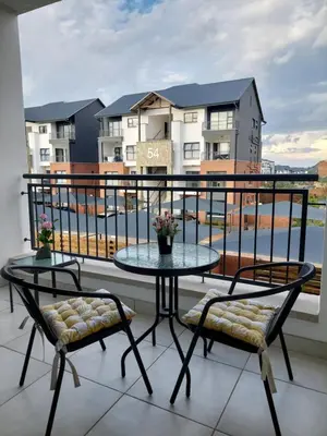 a balcony with a table and two chairs and a view at Craiden Holiday Apartment at The Blyde Crystal Lagoon 2 bedrooms in Pretoria