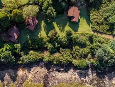 an overhead view of a house on a field with trees at Lisbon Eco Lodge in Graskop