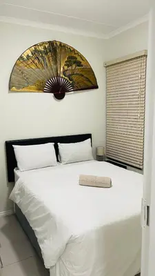 a bedroom with a large white bed with a window at 92 On New By Damo in Midrand