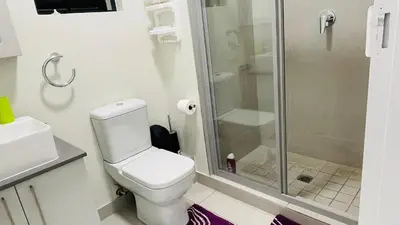 a bathroom with a toilet and a glass shower at 92 On New By Damo in Midrand
