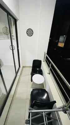 a waiting room with two chairs and a table at 92 On New By Damo in Midrand