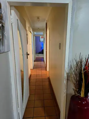 a hallway in a house with a vase at Sabie House -3 bedrooms, OR Tambo, Kempton Park, Johannesburg in Kempton Park
