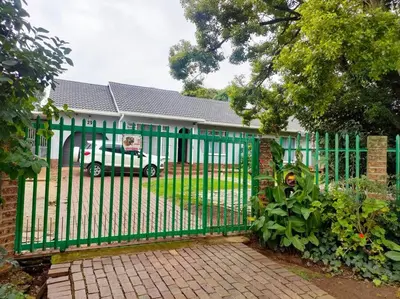 a green fence in front of a house at Sabie House -3 bedrooms, OR Tambo, Kempton Park, Johannesburg in Kempton Park