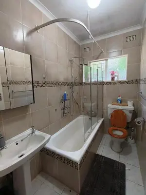 a bathroom with a tub and a toilet and a sink at Sabie House -3 bedrooms, OR Tambo, Kempton Park, Johannesburg in Kempton Park