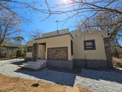 a small white building with stairs in front of it at Marloth Cottage in Marloth Park