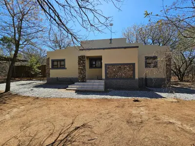 a house in the middle of a field at Marloth Cottage in Marloth Park