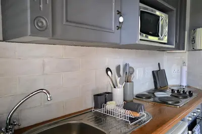 a kitchen counter with a sink and a microwave at Cherry Grove 2 in Dullstroom