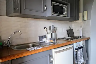 a kitchen counter with a sink and a microwave at Cherry Grove 2 in Dullstroom