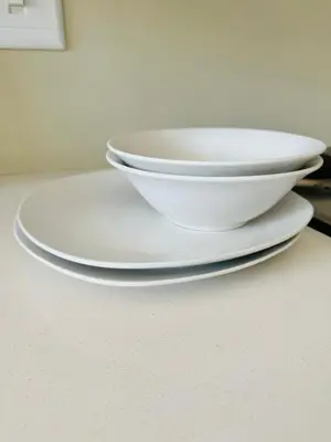 three plates and bowls sitting on a table at Gallagher Midrand BnB in Midrand