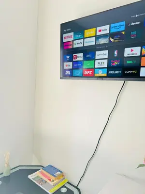 a flat screen tv hanging on a wall at Gallagher Midrand BnB in Midrand