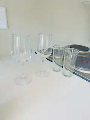 four empty wine glasses sitting on a counter at Gallagher Midrand BnB in Midrand