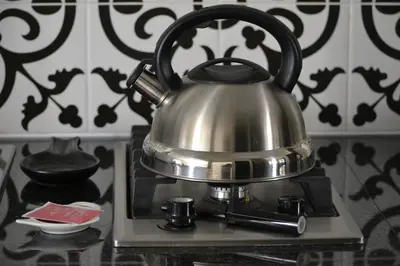 a tea kettle sitting on top of a stove at Zebra Cottage in Pretoria