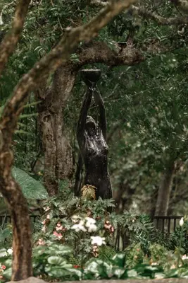 a statue of a woman holding up a vase at The Green Lizard Guesthouse in Nelspruit