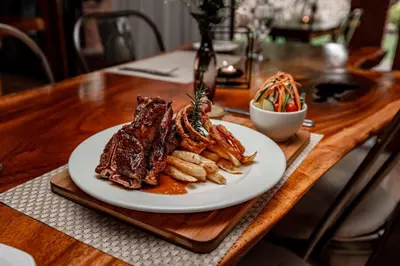 a plate of food on a wooden table at The Green Lizard Guesthouse in Nelspruit