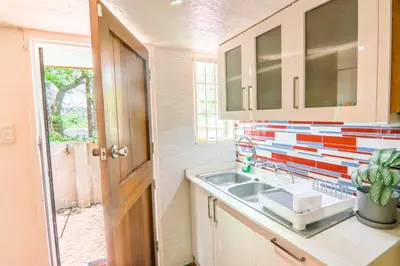 a kitchen with a sink and a colorful wall at Brooklyn's Holiday Home in Pretoria