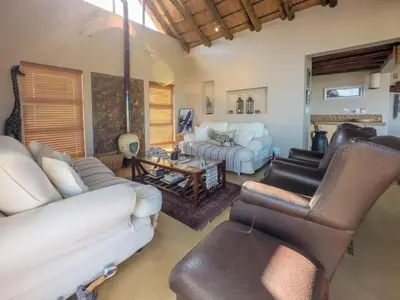 a living room with a couch and a table at Des'lgodini Lodge - PRM078 in Bela-Bela