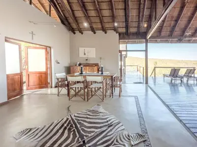 a kitchen and dining room with a table and chairs at Des'lgodini Lodge - PRM078 in Bela-Bela