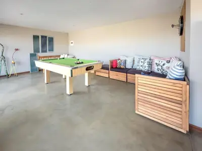 a room with a ping pong table and a couch at Des'lgodini Lodge - PRM078 in Bela-Bela