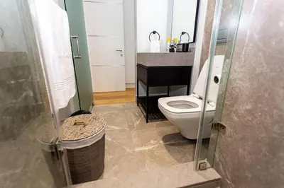 a bathroom with a toilet and a glass shower at Upmarket Executive Luxury Apartment in Midrand