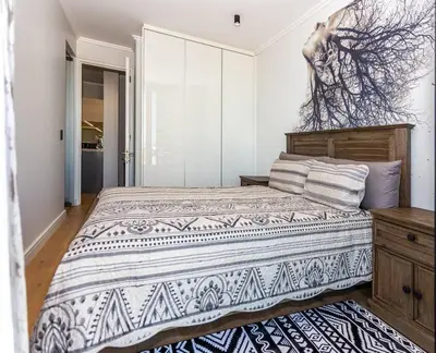 a bedroom with a large bed in a room at Upmarket Executive Luxury Apartment in Midrand
