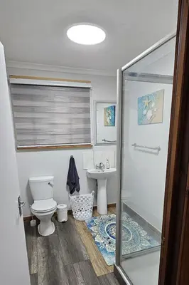 a bathroom with a shower and a toilet and a sink at The Big tree @ Sabie in Sabie