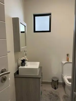 a bathroom with a sink and a toilet at Spacious 2 Bedroom Apartment in Carslwald, Midrand - Business and Family friendly - 1 Harriet Place in Midrand