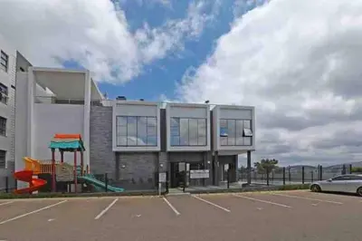 a building with a playground in a parking lot at Spacious 2 Bedroom Apartment in Carslwald, Midrand - Business and Family friendly - 1 Harriet Place in Midrand