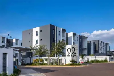 a large white building with a sign in front of it at Spacious 2 Bedroom Apartment in Carslwald, Midrand - Business and Family friendly - 1 Harriet Place in Midrand