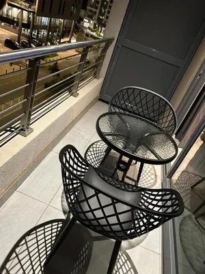 a table and four chairs on a balcony at Triology Menlyn Maine Residences in Pretoria