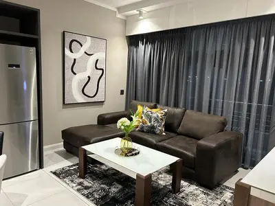 a living room with a couch and a coffee table at Triology Menlyn Maine Residences in Pretoria