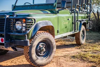 a green truck parked on a dirt road at Kubu Lodge in Mabula