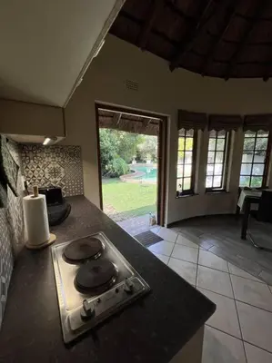 a kitchen with a stove and a counter top at SHONALANGA - Secured cottage in equestrian estate - LOADSHEDDING FREE! in Midrand